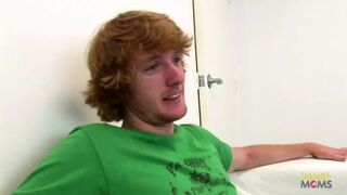 At work, a slender individual engages in sexual intercourse with a coworker who has a striking red hair.